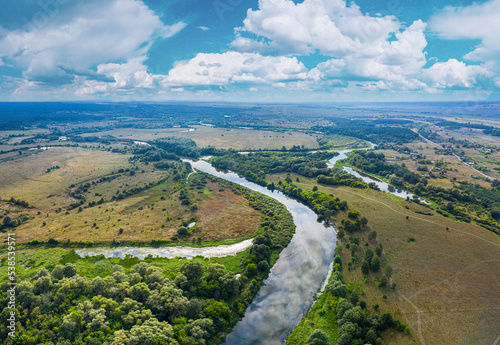 Beautiful Ukrainian nature background. Drone view on riverbank of the Seym river and amazing cloudscape over it. Summertime. photo