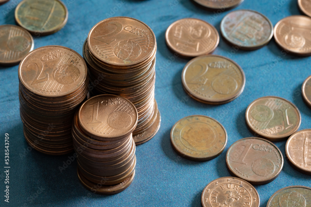 Stacks of euro cents coins on metal surface. Money saving concept Stacks of euro cents coins on metal surface. Money saving concept