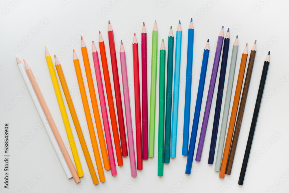 Colored pencils on a white background. Multicolored pencils.