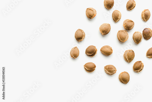 Apricot kernels on a white background. Apricot kernels.