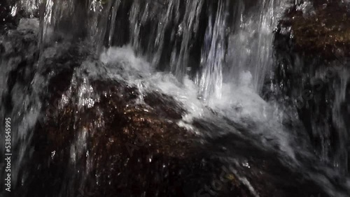 water flowing over rocks, close-up