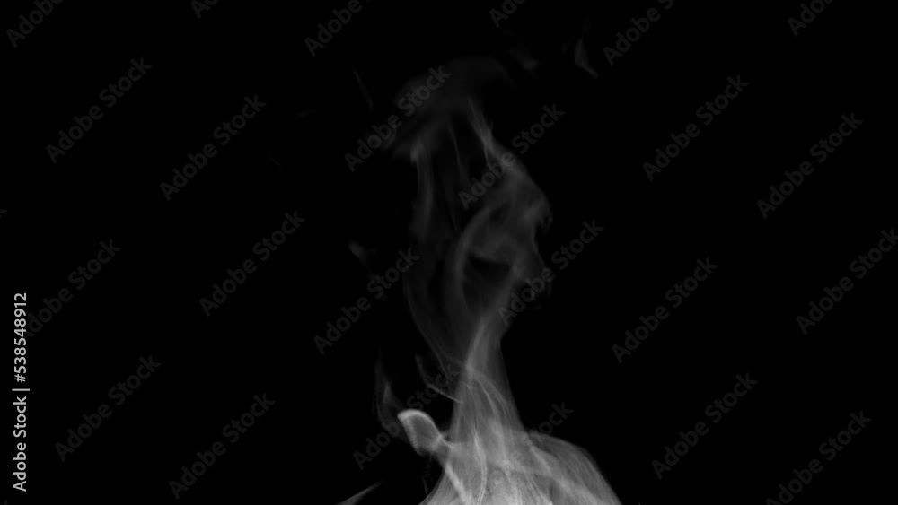 White steam isolated on black. Trickle of Steam Slowly Rising from the Cup. White steam rises graceful twists on a black background. Footage is perfect for the layer with different blending modes.