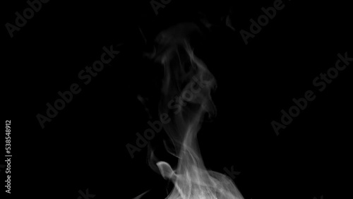 White steam isolated on black. Trickle of Steam Slowly Rising from the Cup. White steam rises graceful twists on a black background. Footage is perfect for the layer with different blending modes.