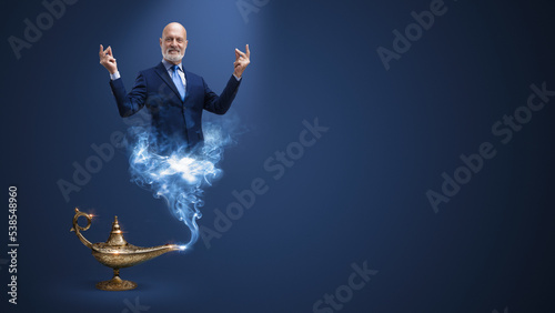 Businessman genie coming out from the lamp photo