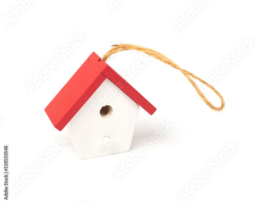 Christmas tree toy in the form of a birdhouse on a white background. Christmas decoration, wooden toy.