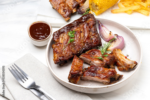 Foto Spare ribs Grilled pork ribs with barbecue sauce and ketchup and grilled vegetab