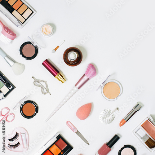 Feminine makeup pink red orange palette accessories with nail polish manicure tools on white background. Flat lay pattern with copy space, beauty and cosmetics blogger concept banner