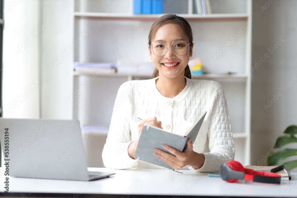 Attractive young woman working with laptop at home office. Attractive young woman working with laptop at home office.
