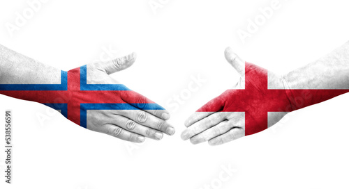 Handshake between England and Faroe Islands flags painted on hands, isolated transparent image.