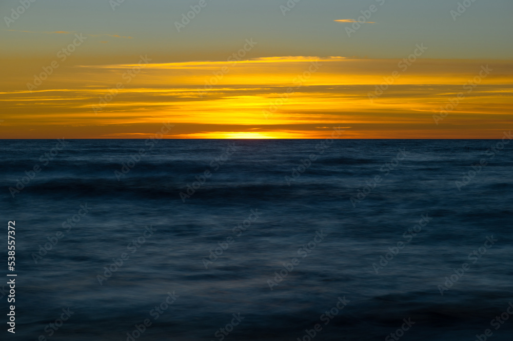 Abstract sea at sunset background. Artistic motion blur