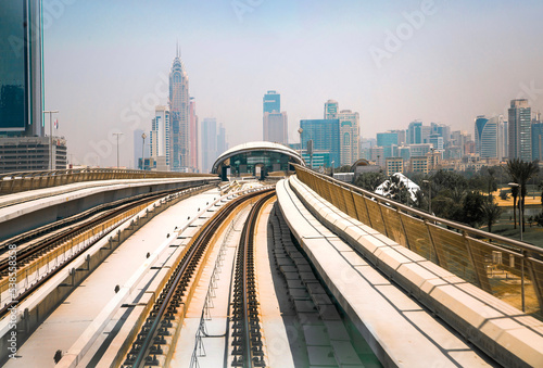 Dubai, UAE. Train, tube track with  train station and  City view at the distance