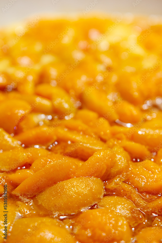 Apricots are cooked in a pan. Apricot jam. Pieces of fruit. Home preservation. Apricots are cooked in a pan. Apricot jam. Pieces of fruit. Home preservation.