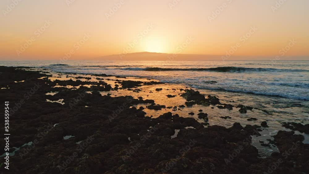 Beautiful sunset over the sea. Solar path on the surface of the salty water of the golden clear ocean. Evening landscape. Waves foaming. Paradise dreamy island. Drone flight to the sun. Beautiful sunset over the sea. Solar path on the surface of the salty water of the golden clear ocean. Evening landscape. Waves foaming. Paradise dreamy island. Drone flight to the sun.