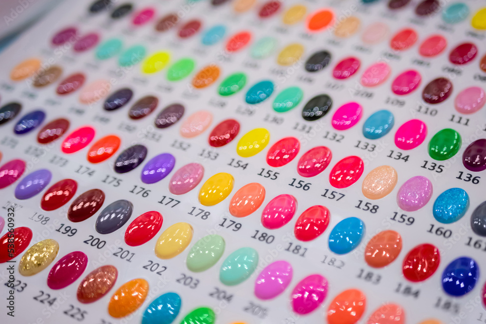 Set of nail art color palette on counter of make up store, manicure salon, exhibition - close up view. Fashion, care, cosmetic, beauty, makeup and glamour concept