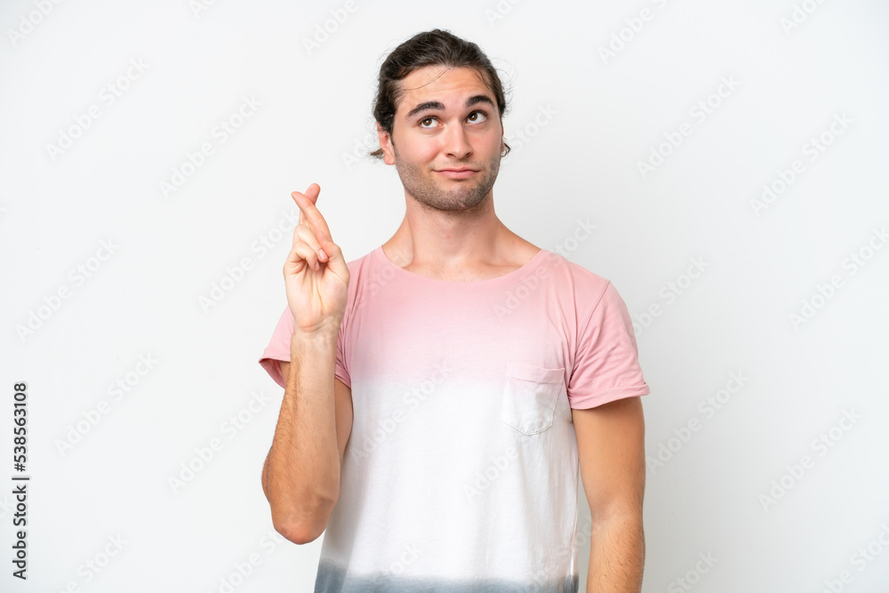 Caucasian handsome man isolated on white background with fingers crossing and wishing the best Caucasian handsome man isolated on white background with fingers crossing and wishing the best