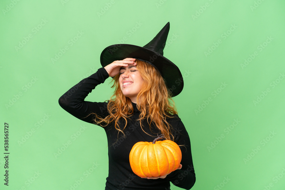 Young caucasian woman costume as witch holding a pumpkin isolated on green screen chroma key background has realized something and intending the solution Young caucasian woman costume as witch holding a pumpkin isolated on green screen chroma key background has realized something and intending the solution