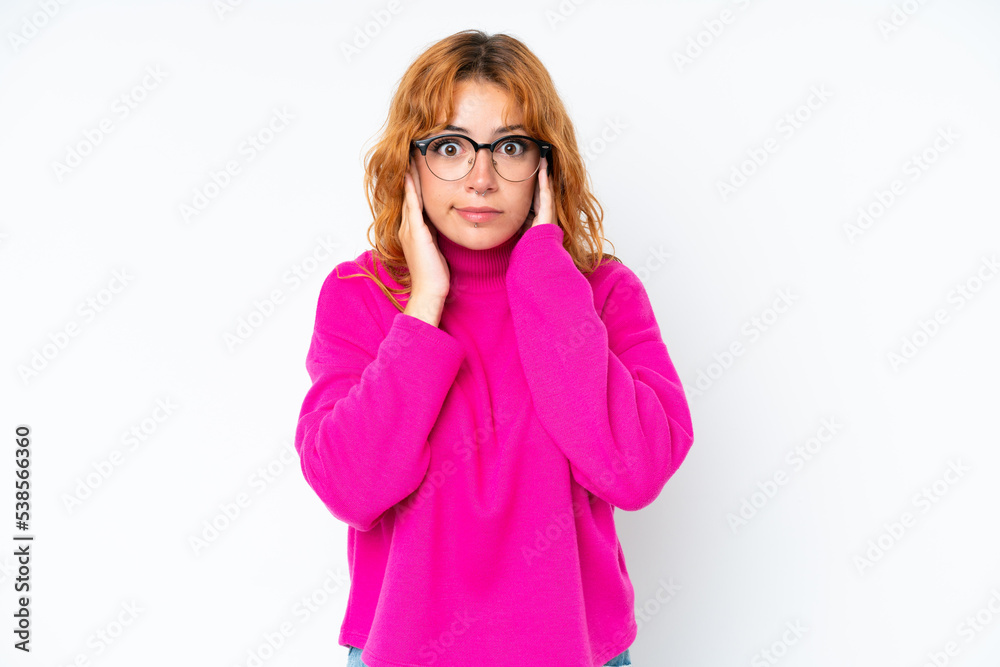 Young caucasian woman isolated on white background frustrated and covering ears