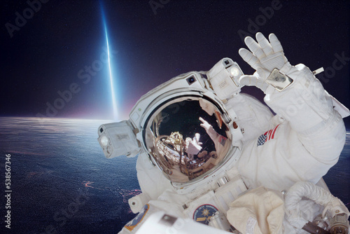 Fototapeta Naklejka Na Ścianę i Meble -  The astronaut on a background of a planet. Elemen ts of this image furnished by NASA, 3d render.