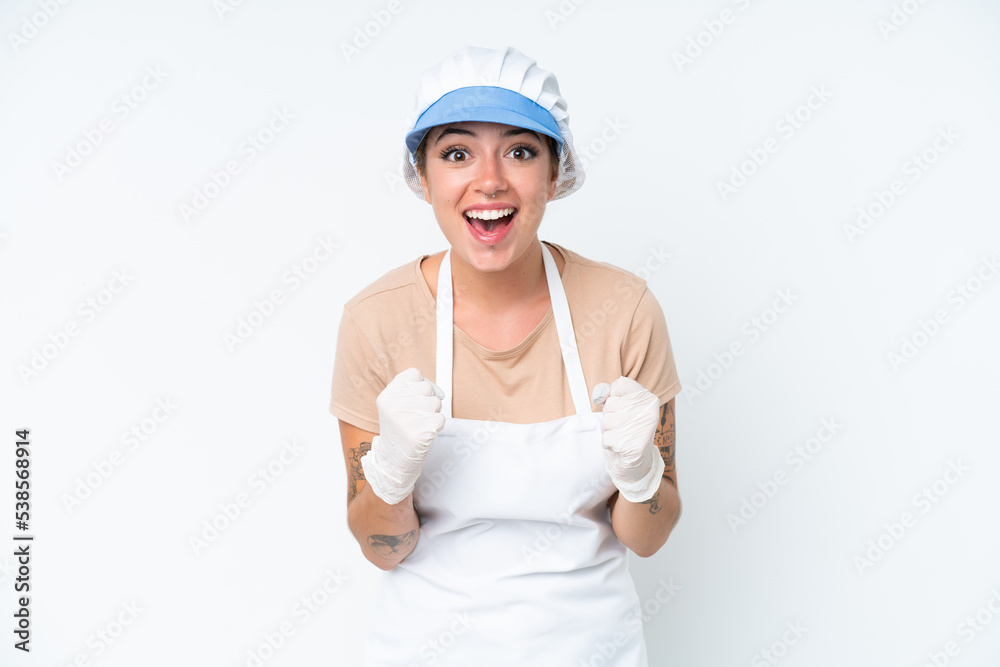 Fishmonger wearing an apron and holding a raw fish isolated on white background celebrating a victory in winner position Fishmonger wearing an apron and holding a raw fish isolated on white background celebrating a victory in winner position