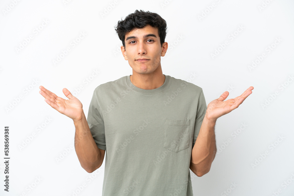 Young Argentinian man isolated on white background making doubts gesture Young Argentinian man isolated on white background making doubts gesture