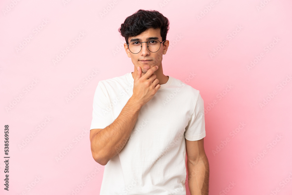 Young Argentinian man isolated on pink background thinking Young Argentinian man isolated on pink background thinking
