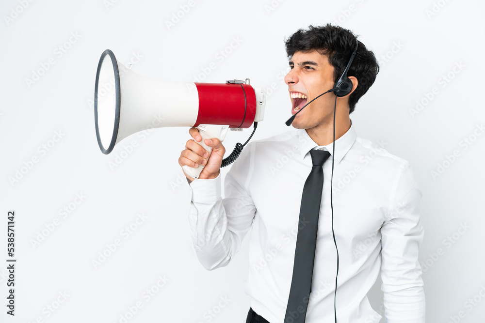 Telemarketer man working with a headset isolated on white background shouting through a megaphone Telemarketer man working with a headset isolated on white background shouting through a megaphone