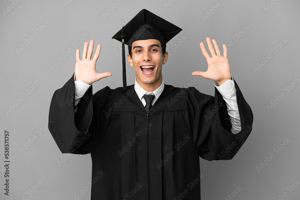 Young Argentinian university graduate isolated on grey background counting ten with fingers Young Argentinian university graduate isolated on grey background counting ten with fingers