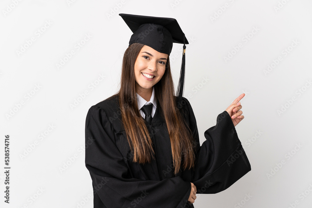 Teenager Brazilian university graduate over isolated white background pointing finger to the side Teenager Brazilian university graduate over isolated white background pointing finger to the side