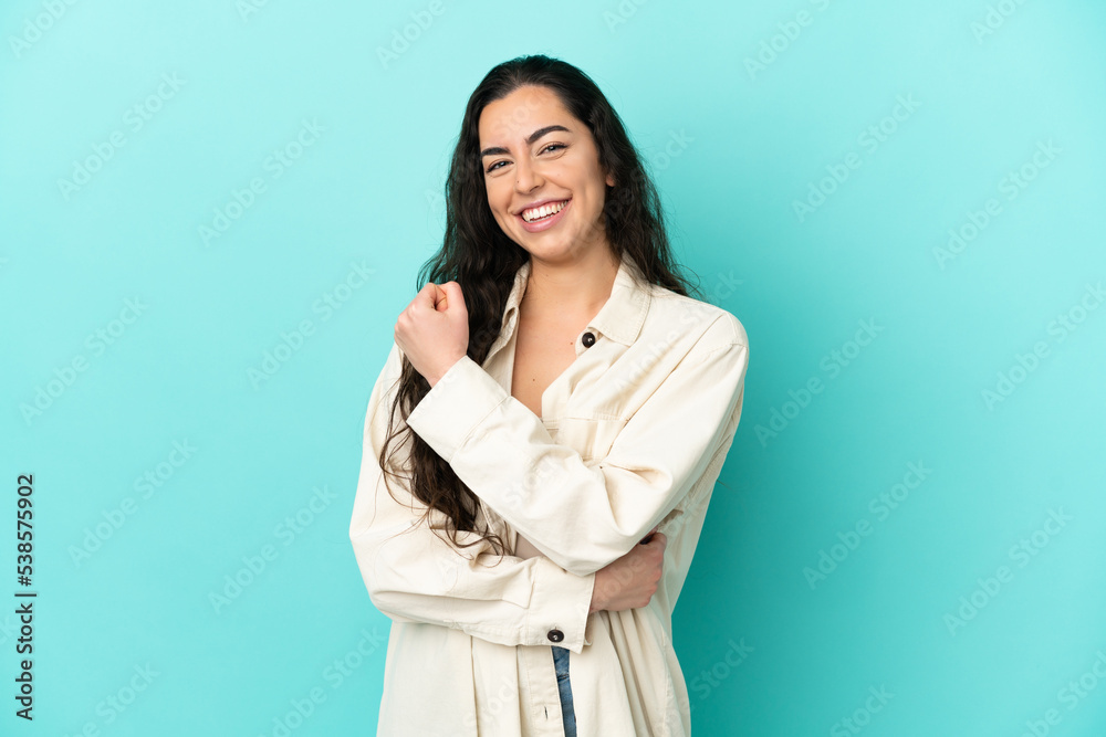 Young caucasian woman isolated on blue background celebrating a victory Young caucasian woman isolated on blue background celebrating a victory