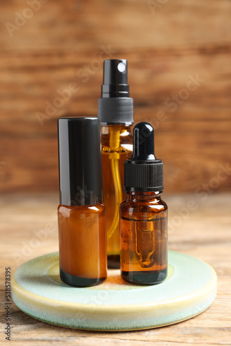Bottles with oil on wooden table. Natural cosmetics