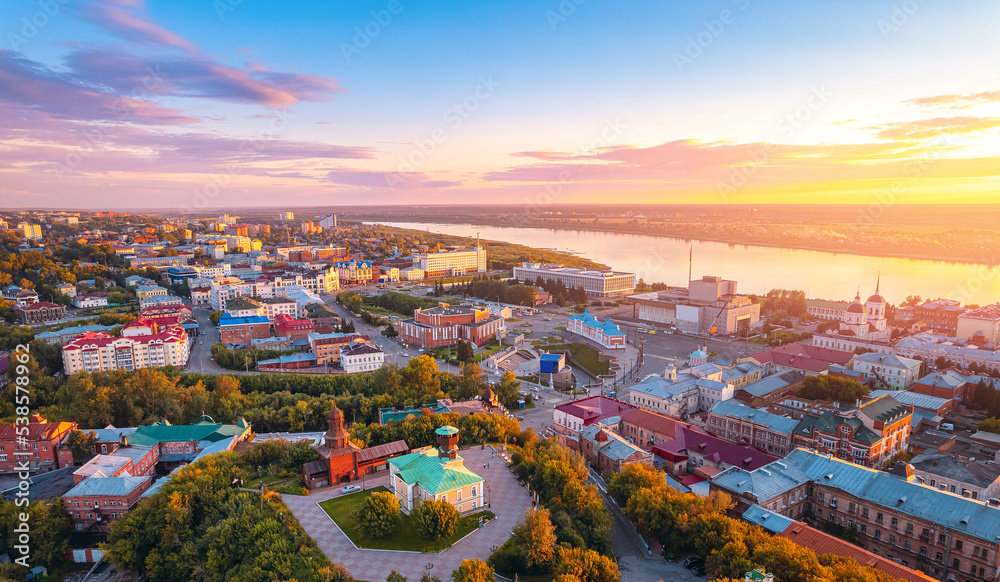 Naklejka premium Panorama city Tomsk and Tom River with sunlight. Aerial top view