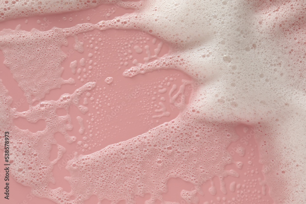 Fototapeta premium White washing foam on pale pink background, top view