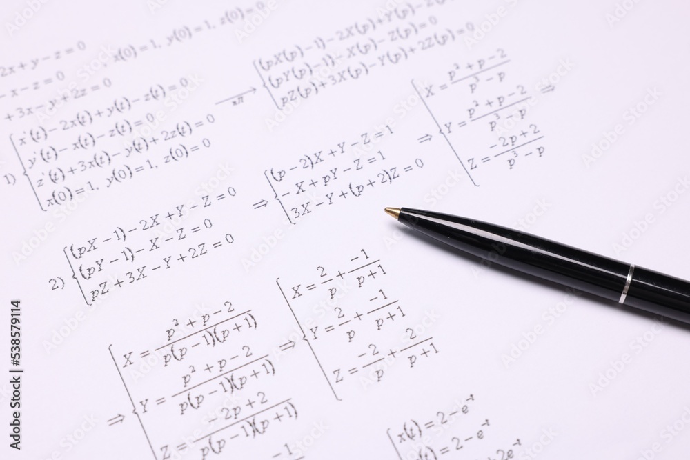 Sheet of paper with mathematical formulas and pen Sheet of paper with mathematical formulas and pen