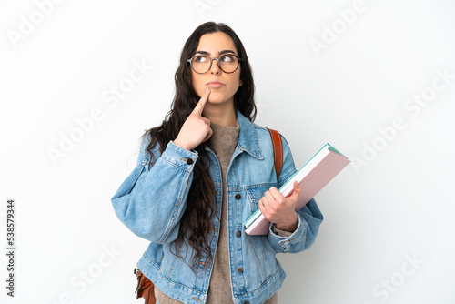 Young student woman isolated on white background having doubts while looking up