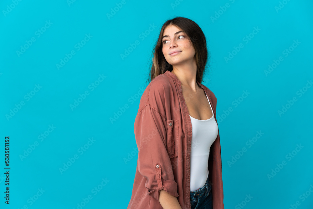 Young caucasian woman isolated on blue background . Portrait Young caucasian woman isolated on blue background . Portrait