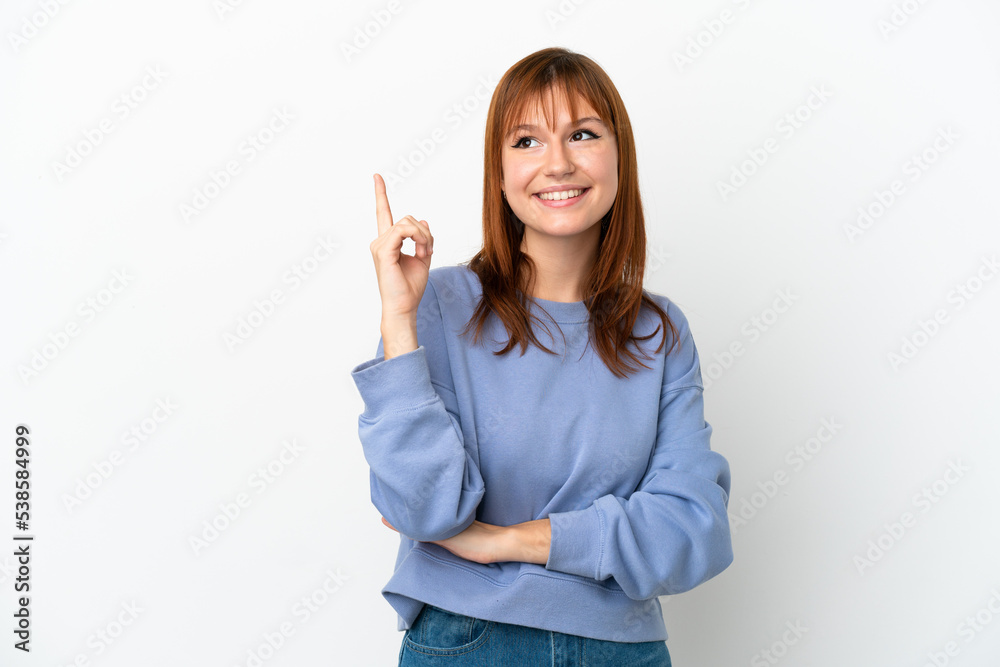 Redhead girl isolated on white background pointing up a great idea Redhead girl isolated on white background pointing up a great idea