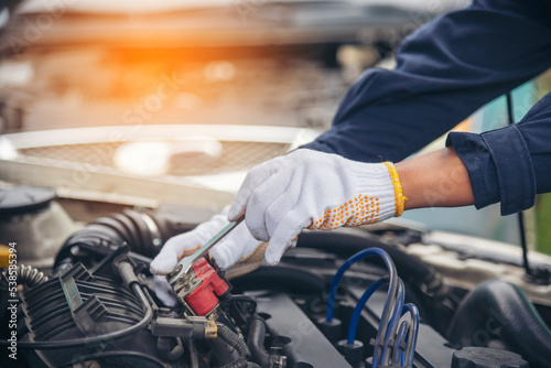 Close up Man hands fixing Car machinery vehicle mechanical service. Mechanic man hands repairing car auto repair shop. open vehicle hood checking up auto mobile. Vehicle Car maintenance engineer.