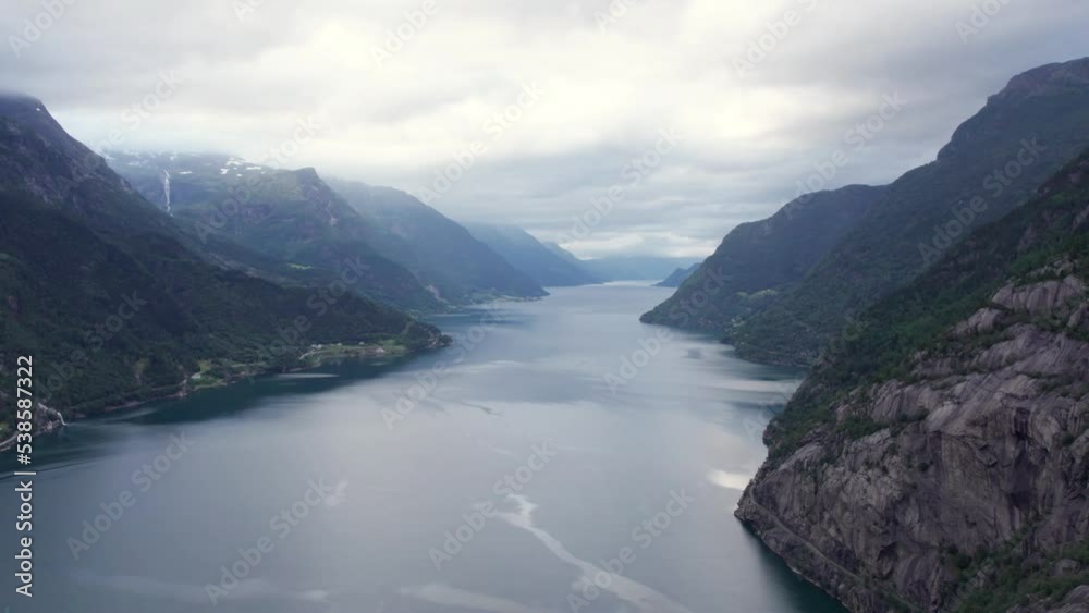 drone flies through clouds, aerial view of fjord and waterfall drone flies through clouds, aerial view of fjord and waterfall