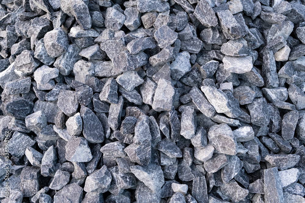 Heap of Gray crushed stones cobblestones on street road construction site. Full frame textured background. Heap of Gray crushed stones cobblestones on street road construction site. Full frame textured background.