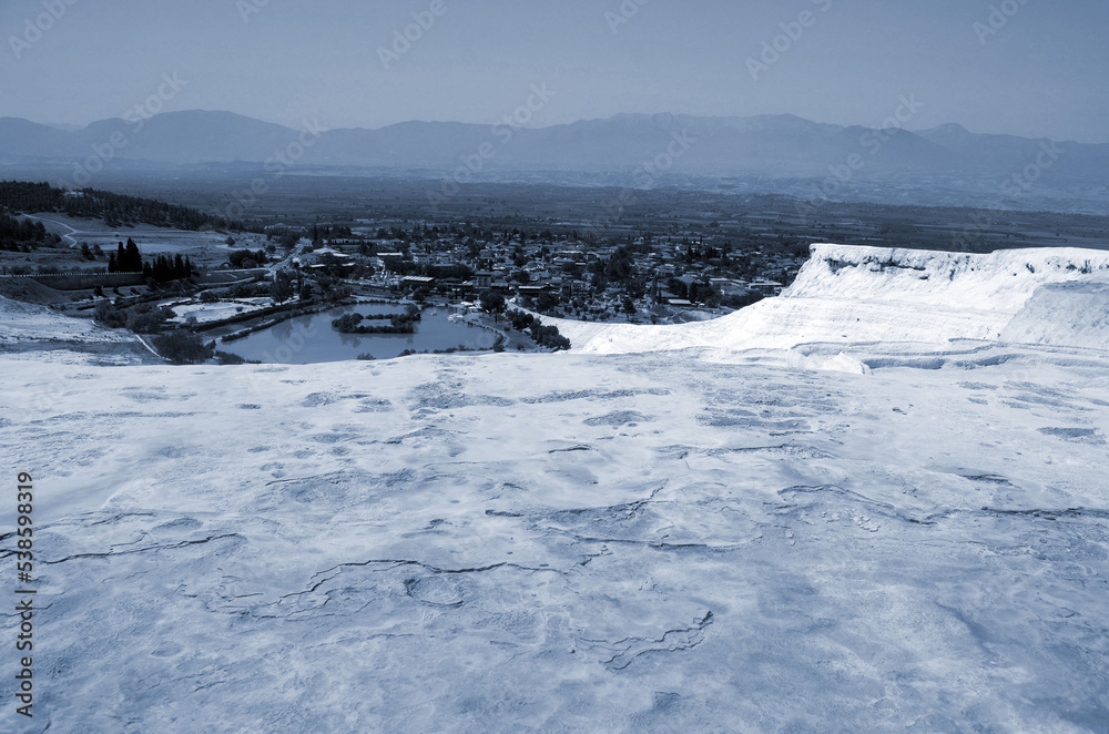 Pamukkale landsape. White terraces with natural travertines in Pamukkale. Amazing scenery of calcium mountains in Turkey.