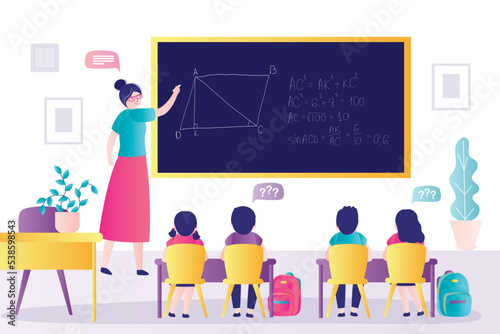 Teacher explains mathematical problems to younger grades. Students listen to solution of problem written on blackboard