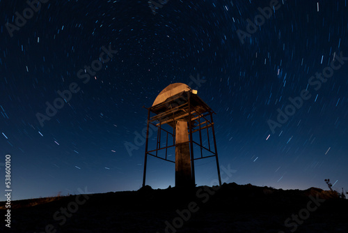 Night sky, a lonely building among the mountains