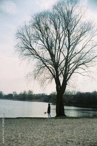 Man by the tree by the river on film