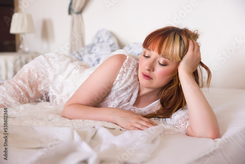 Posing woman in sheer lace nightgown