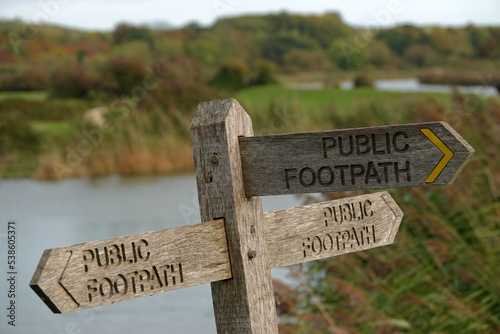Public footpath sign beside English river.