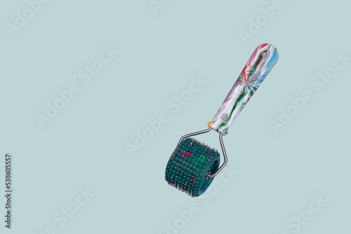 Head and body massage roller on a green background. Health care concept. Applicator Kuznetsov Acupressure Massage photo