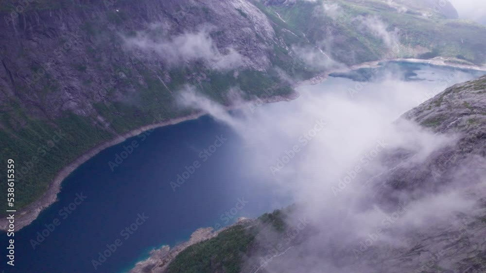drone flies through the clouds aerial view of the fjord, the reflection of the mountains and the sky in the lake drone flies through the clouds aerial view of the fjord, the reflection of the mountains and the sky in the lake