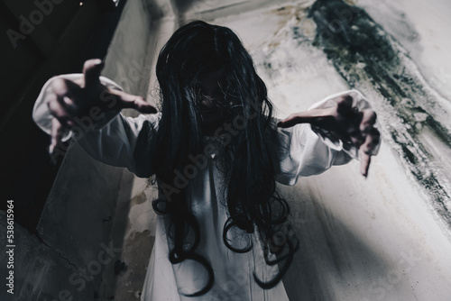 Photography Woman in ghost or zombie on halloween festival at dark abandon place, threatening and wants to attack you
