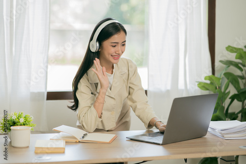 Asian woman working with customers in office