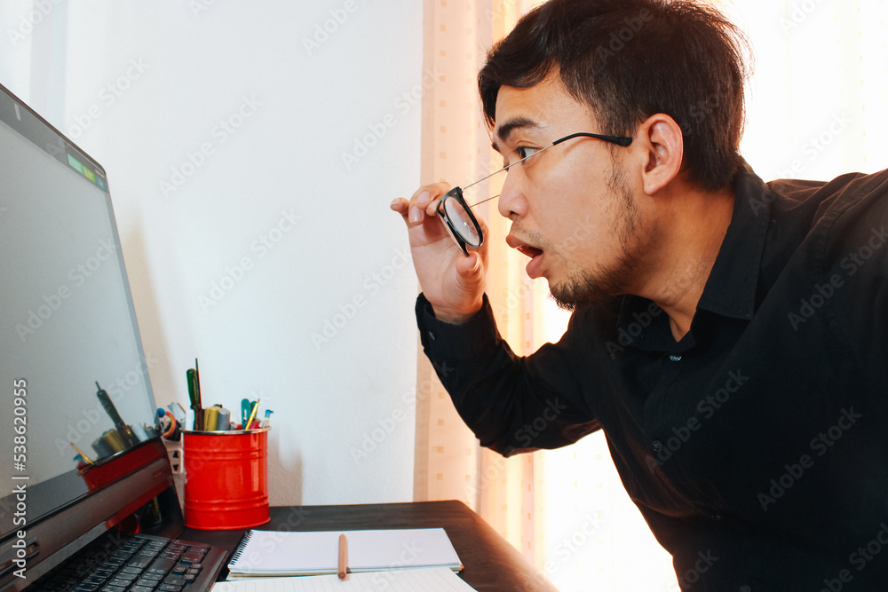 Furious businessman screaming in front of his laptop Furious businessman screaming in front of his laptop